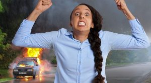Angry woman with a burning car in the background