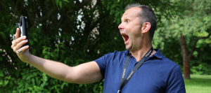Man with a funny expression taking a selfie.