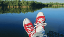 FUTAB: Feet up, take a break. Photo of a person's feet up against a background of a beautiful lake.