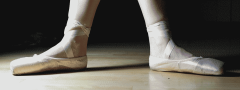 Photo of feet flat on floor in ballet shoes