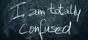 Words written on blackboard: I am totally confused