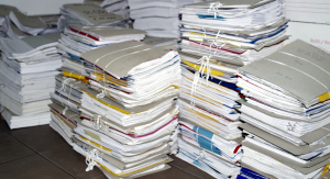 Paper, paper everywhere! Photo of stocks of paper files.