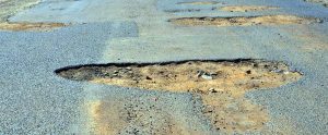 Photo of a road with potholes