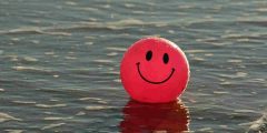Just 12 minutes to happiness - image of a cartoon smiley face floating in the sea.