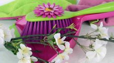 Spring clean your comments - bright image of a dustpan and brush with flowers
